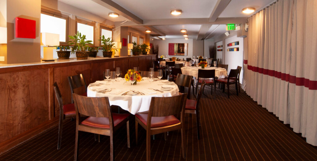 Dining room with round top tables, fully set